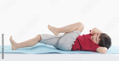 little boy performs an exercise for the press.isolated on white