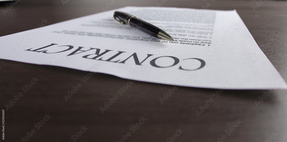 close up. a pen and a sheet with the signed contract close up. a pen and a sheet with the signed contract