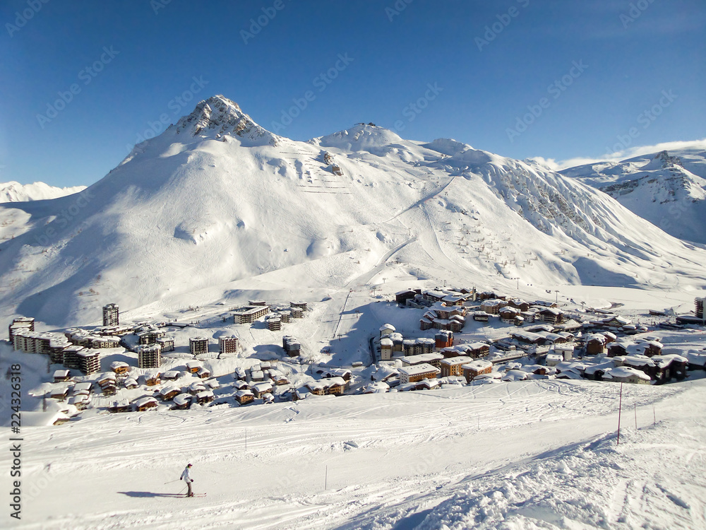 Fototapeta premium Ski resort of Tignes in winter, ski slope and village of Tignes le lac in the background