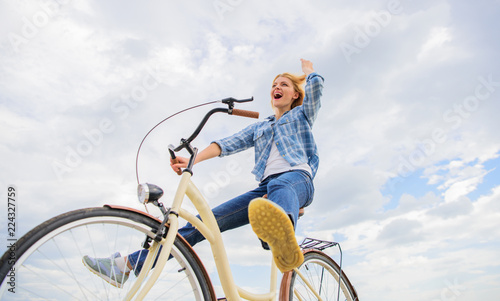 Most satisfying form of self transportation. Cycling gives you feeling of freedom and independence. Girl rides bicycle sky background. Freedom and delight. Woman feels free while enjoy cycling
