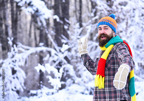 Macho with beard and mustache plays with snowball.