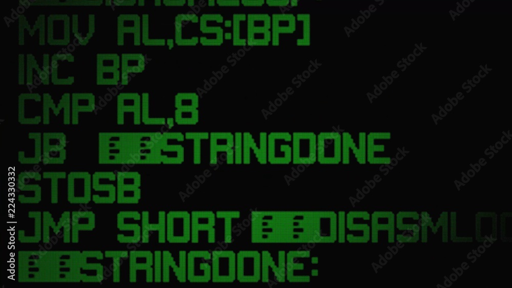 Source code on a computer LCD screen. Green on black, big striped assembly instructions.
