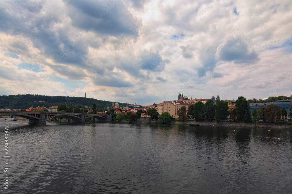 Scenic view of historical center of Prague, Manes Bridge and Vltava river at cloudy summer day. Buildings, cathedrals and landmarks of old town, Prague, Czech Republic