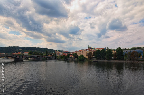 Scenic view of historical center of Prague, Manes Bridge and Vltava river at cloudy summer day. Buildings, cathedrals and landmarks of old town, Prague, Czech Republic