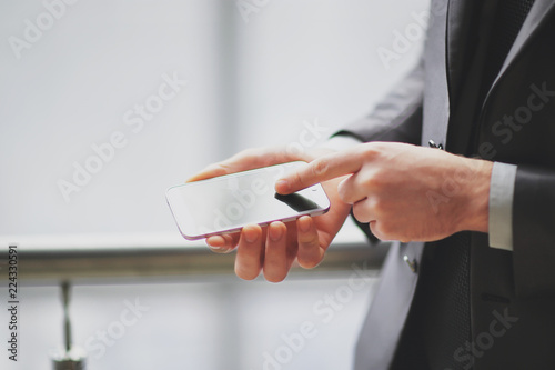 close up.a businessman uses a smartphone.people and technology