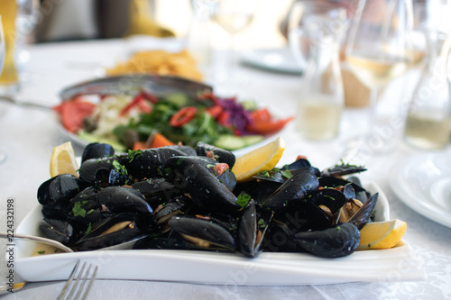 Cooked mussels served on the table with salad. Albania. Adriatic coast. National food photo