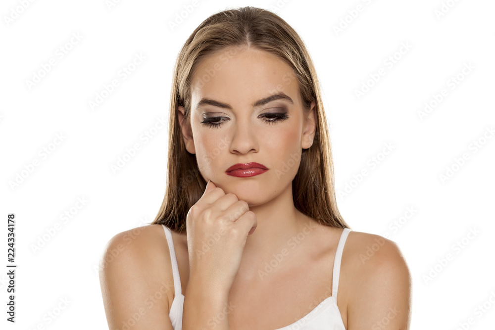 Nervous beautiful pensive nad sad girl on white background Nervous beautiful pensive nad sad girl on white background