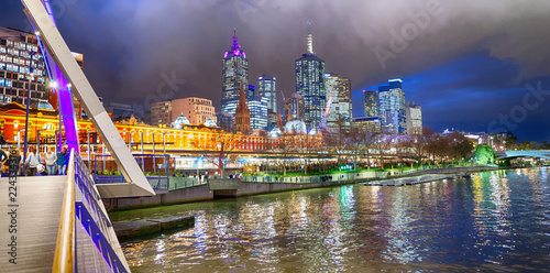 City skyscrapers and Yarra river at night from Southbank Footbridge, Melbourne. photo