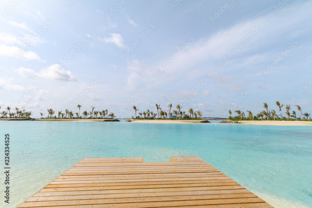 Amazing island in the Maldives ,wooden bridge and  beautiful  turquoise waters with  blue sky  background for holiday vacation .