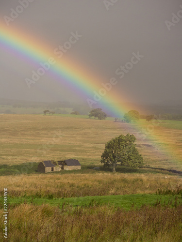 Rainbow over disused barn