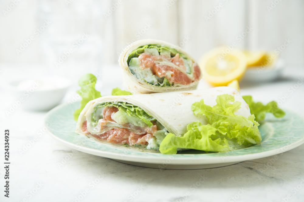 Salmon wraps with lettuce, cucumber and lemon