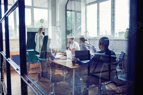 Working hard to win. Businesswoman conducting a business presentation using flipchart while working in the creative office.