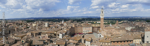 Panorama photo of the cityscape of medieval Siena with old town hall (Palazzo Pubblico) in Tuscany, Italy