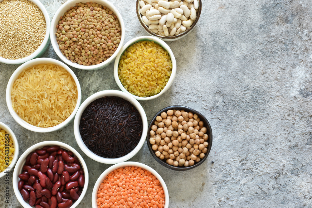 Variation of cereals in bowls: beans, rice, chickpeas, peas on a concrete background. Variation of cereals in bowls: beans, rice, chickpeas, peas on a concrete background.