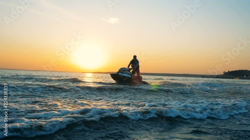 Person doing stunts on a jet ski, close up. photo