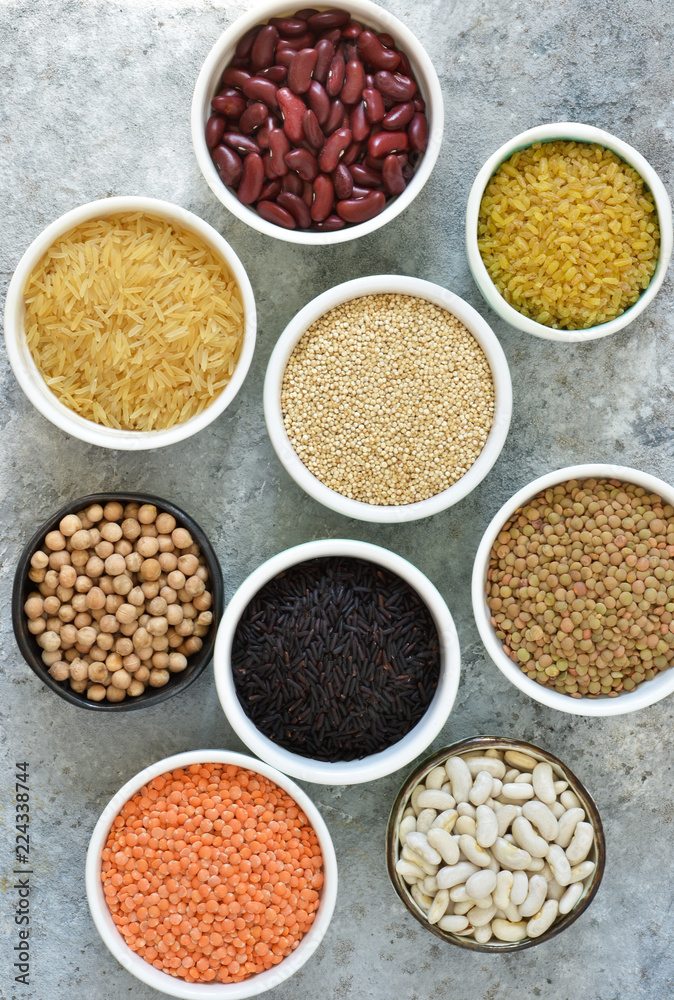 Variation of cereals in bowls: beans, rice, chickpeas, peas on a concrete background. Variation of cereals in bowls: beans, rice, chickpeas, peas on a concrete background.