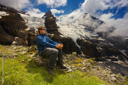 Tourist watching a mountain landscape with glaciers and peaks nearby resort of Kandersteg, Switzerland
