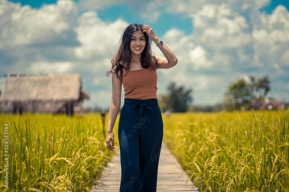 Beauty Women Outdoors enjoying nature. Beautiful Teenage Model girl in white dress running on the Spring Field, Sun Light.