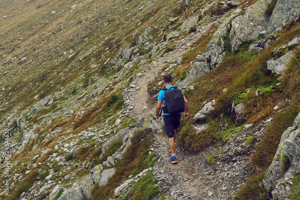 Hiker with backpack in the mountains