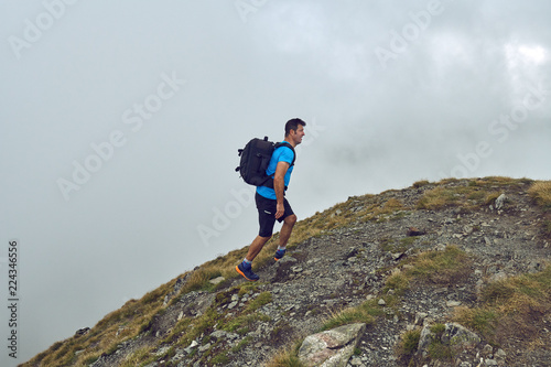 Hiker with backpack in the mountains
