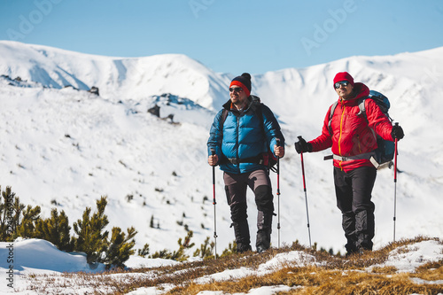Two climbers are in the mountains.