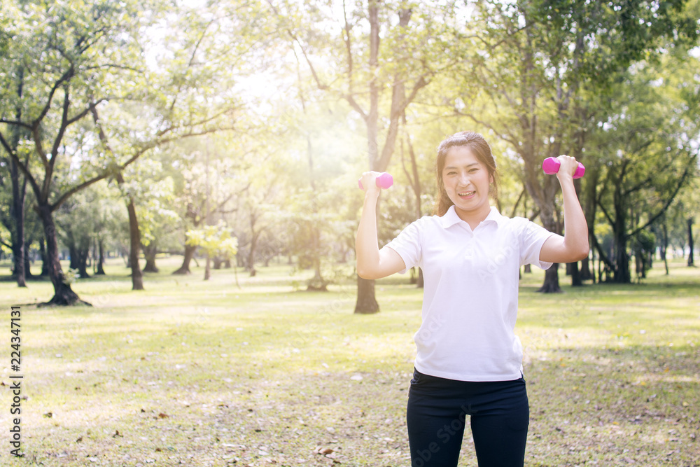 sport woman exercise with dumbbell in park