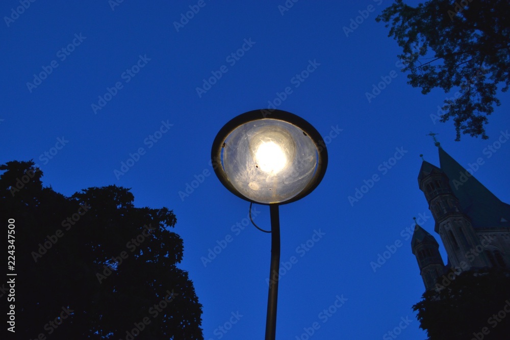 Street electric lantern on a dark sky background.Germany, Cologne Street electric lantern on a dark sky background.Germany, Cologne
