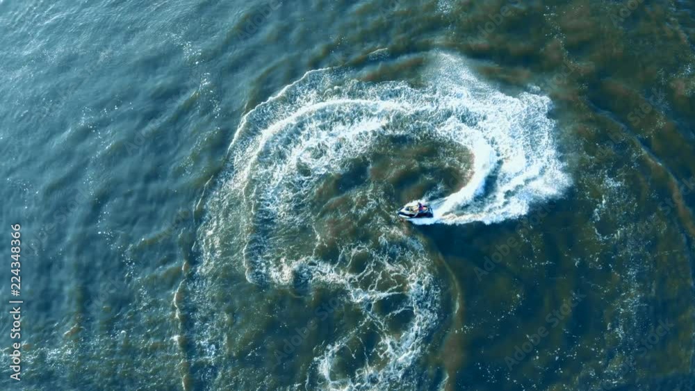 Jet ski rider making splashes, top view. Jet ski rider making splashes, top view.
