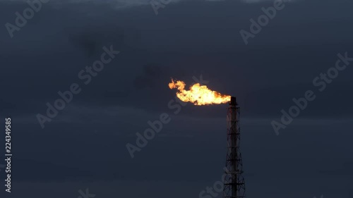 Gas flare of petrochemical refinery in twilight