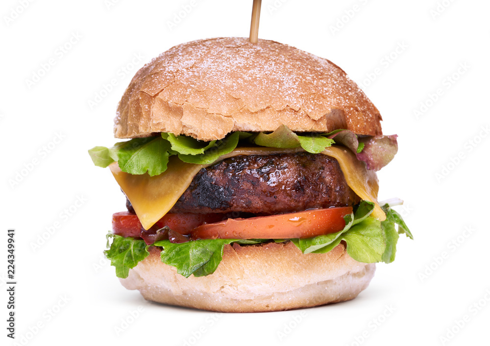 A cheese burger with lettuce, tomatoes and crusty bread bun isolated on a white background.