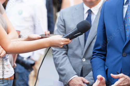 Journalists making media interview with unrecognizable business person or politician