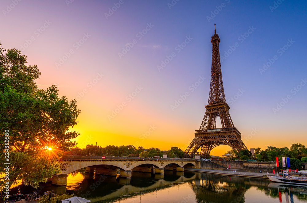 View of Eiffel Tower and river Seine at sunrise in Paris, France. Eiffel Tower is one of the most iconic landmarks of Paris