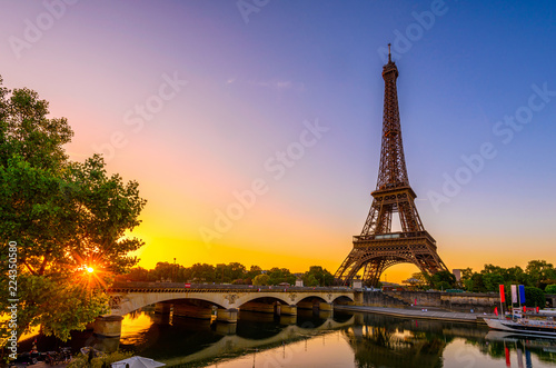 View of Eiffel Tower and river Seine at sunrise in Paris, France. Eiffel Tower is one of the most iconic landmarks of Paris #224350580