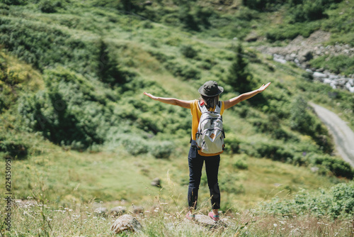 Freedom traveler woman standing with raised arms and enjoying.