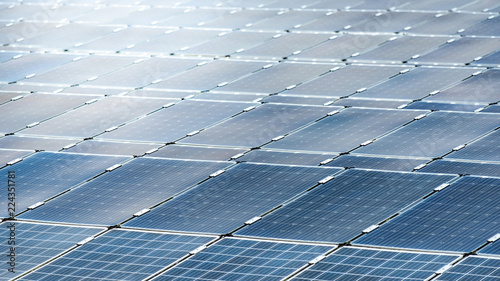 Rows array of solar panels or polycrystalline silicon solar cells in solar power plant using sunlight energy to generate electricity. Photovoltaic modules for renewable energy photo