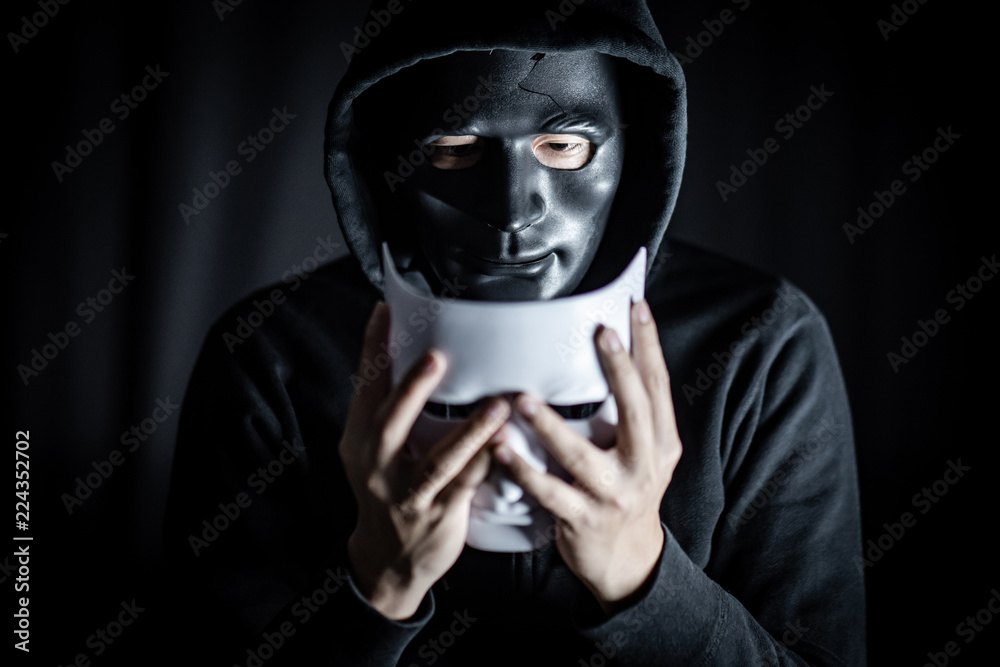 Mystery Hoody Man Wearing Black Mask Holding Two White Masks In His Hand  Anonymous Social Masking Major Depressive Disorder Or Bipolar Disorder  Halloween Concept Stock Photo - Download Image Now - iStock