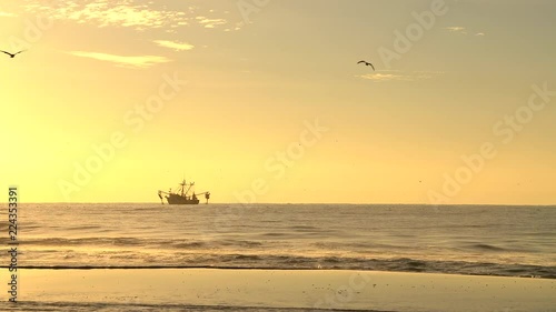 Sunrise behind a local shrimp boat in Emerald Isle, NC photo