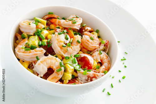 salad with steamed shrimps, cherry tomatoes, corn, and avocado dressed with mayonnaise and decorated with green onion