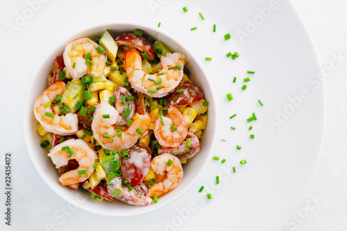 mayo based salad with steamed prawns, cherry tomatoes, corn, and avocado decorated with green onion