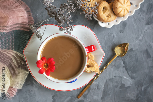 Morning hot chocolate in the original white Cup with a blue button on the background of biscuits. Invigorating Breakfast © oksanamedvedeva