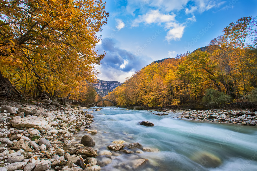Old stone bridge in Klidonia Zagoria, Epirus, Western Greece. This arch bridge with elongated arch built in 1853.(Soft Focus) Long exposure using ND filter Old stone bridge in Klidonia Zagoria, Epirus, Western Greece. This arch bridge with elongated arch built in 1853.(Soft Focus) Long exposure using ND filter