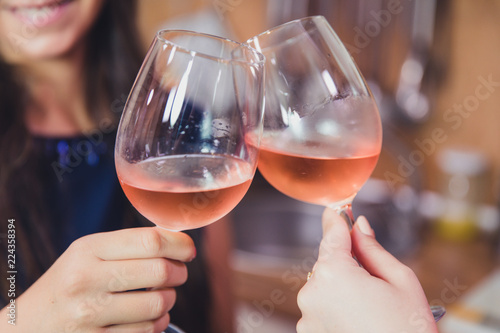 Close up of friends toasting with wine.