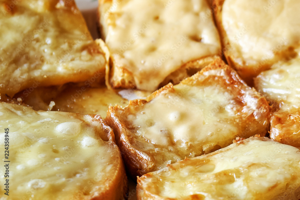 Freshly baked hot toasts with melted cheese close-up Freshly baked hot toasts with melted cheese close-up