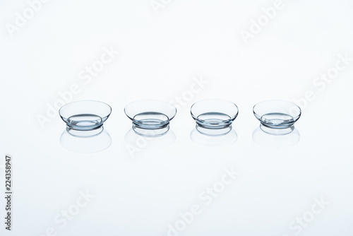 close up view of contact lenses arranged on white backdrop