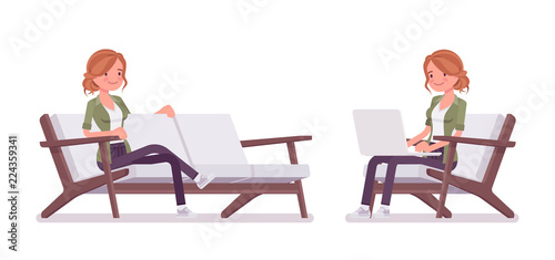 Young red-haired woman sitting and resting, working with laptop