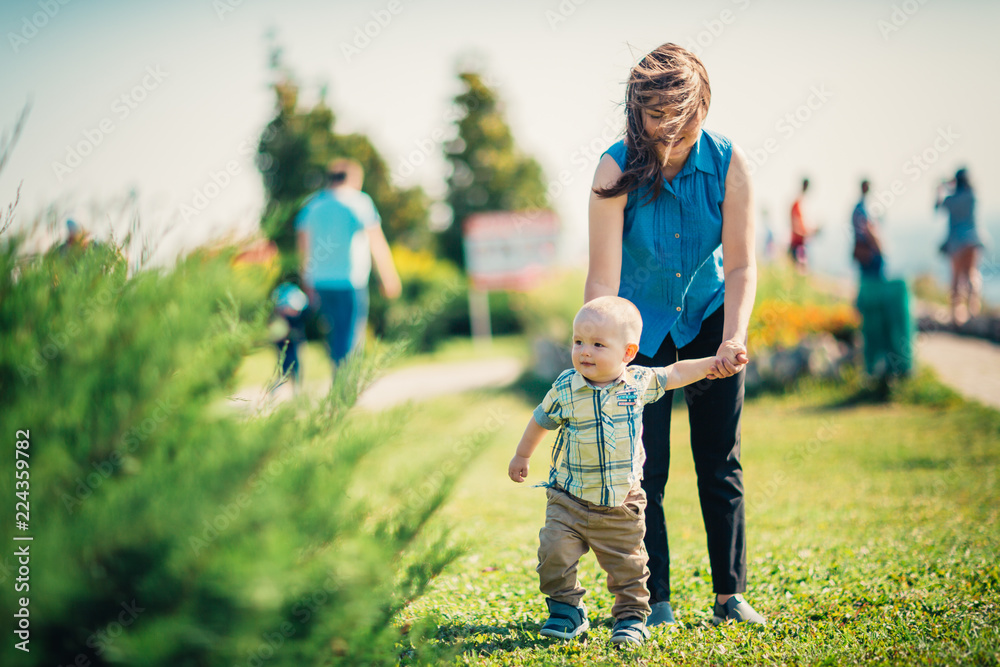 Fototapeta premium happy mother and toddler son on nature background