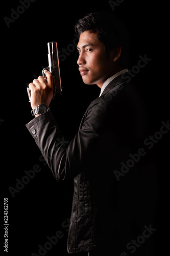 Low key portrait of young man with gun