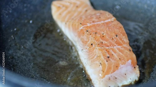 Fresh norwagian orange salmon fish filet was fried in the pan for salmon steak photo