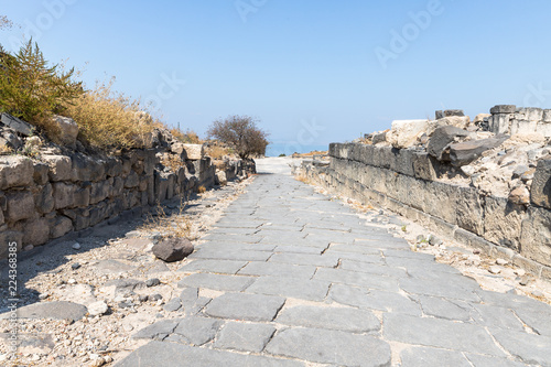 Cobbled  road in the ruins of the Greek - Roman city of the 3rd century BC - the 8th century AD Hippus - Susita on the Golan Heights near the Sea of Galilee - Kineret, Israel photo