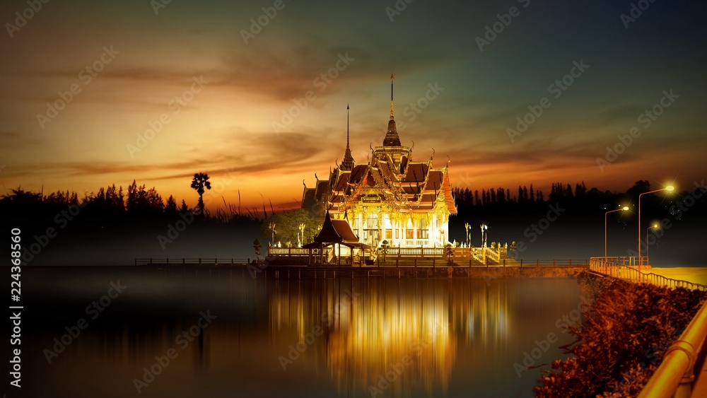 Night Buddhist house on the lake